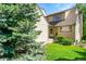 Charming home with lush green lawn, mature trees, and inviting entrance at 10369 E Red Mtn, Littleton, CO 80127