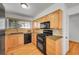 Close up of kitchen features wood cabinets, black appliances, and hardwood floors at 10369 E Red Mtn, Littleton, CO 80127