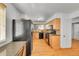 Well-lit kitchen features wood cabinets, black appliances, and hardwood floors at 10369 E Red Mtn, Littleton, CO 80127
