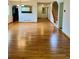 Open-concept living area with hardwood floors, connecting to the staircase and kitchen at 10369 E Red Mtn, Littleton, CO 80127