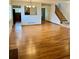 Open-concept living area with hardwood floors, staircase and kitchen view at 10369 E Red Mtn, Littleton, CO 80127