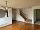 Open concept living area featuring hardwood floors, staircase and kitchen at 10369 E Red Mtn, Littleton, CO 80127