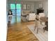 Sunlit living room with hardwood floors, a fireplace, and access to an outdoor patio at 10369 E Red Mtn, Littleton, CO 80127