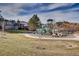 Community playground with slides, climbing structures, and soft ground covering, set against a backdrop of mountains at 10369 E Red Mtn, Littleton, CO 80127