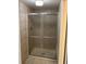 Shower featuring neutral tiles, glass sliding door, and chrome trim at 10369 E Red Mtn, Littleton, CO 80127