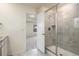 Bathroom with glass shower and tiled surround seen from the bedroom entrance at 26267 E 3Rd Ave, Aurora, CO 80018