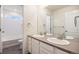 Bathroom with double sink vanity, tile floors, and shower/tub combo at 26267 E 3Rd Ave, Aurora, CO 80018