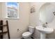 Powder room featuring a pedestal sink, round mirror, and decorative ladder at 26267 E 3Rd Ave, Aurora, CO 80018