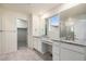 Bathroom with dual vanities, granite counters, walk-in closet access, and a glass-enclosed shower at 26267 E 3Rd Ave, Aurora, CO 80018