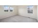 Bright bedroom features carpeting and three windows providing natural light at 26267 E 3Rd Ave, Aurora, CO 80018