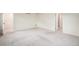 Large bedroom with neutral carpeting and a glimpse into the ensuite bathroom at 26267 E 3Rd Ave, Aurora, CO 80018