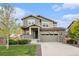 Charming two-story home with stone accents, manicured lawn, and welcoming front porch at 26267 E 3Rd Ave, Aurora, CO 80018
