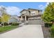 Charming two-story home with stone accents, manicured lawn, and welcoming front porch at 26267 E 3Rd Ave, Aurora, CO 80018