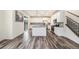 Bright, open kitchen with white cabinets, granite countertops, and stainless steel appliances at 26267 E 3Rd Ave, Aurora, CO 80018