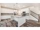 Modern kitchen with stainless steel appliances, a granite island, and wood-look floors at 26267 E 3Rd Ave, Aurora, CO 80018