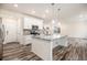 Bright, open kitchen with white cabinets, granite countertops, and stainless steel appliances at 26267 E 3Rd Ave, Aurora, CO 80018