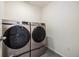 Laundry area features a front-load washer and dryer and tiled floor at 26267 E 3Rd Ave, Aurora, CO 80018