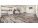 Open-concept living area flows into the kitchen, featuring sleek flooring and ample natural light at 26267 E 3Rd Ave, Aurora, CO 80018