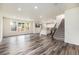 Open-concept living area flows into the kitchen, featuring sleek flooring and ample natural light at 26267 E 3Rd Ave, Aurora, CO 80018