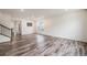 Bright living room with sleek flooring, recessed lighting, and staircase at 26267 E 3Rd Ave, Aurora, CO 80018