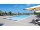 Large community pool featuring a splash pad, covered seating, and several tables with chairs at 26267 E 3Rd Ave, Aurora, CO 80018