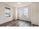 Bright, open room with wood-look floors and large windows offering ample natural light at 26267 E 3Rd Ave, Aurora, CO 80018
