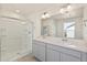 Modern bathroom with a double sink vanity, a glass enclosed shower and neutral color palette at 4107 Marble Dr, Mead, CO 80504