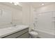 Bathroom featuring a bathtub-shower combo, gray vanity and neutral finishes at 4107 Marble Dr, Mead, CO 80504