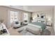 Bright bedroom featuring neutral decor, plush bed, and a sitting area at 4107 Marble Dr, Mead, CO 80504