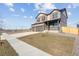 Two-story home with covered porch, three car garage, and newly planted sapling at 4107 Marble Dr, Mead, CO 80504