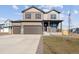 Two-story home featuring a covered porch, three car garage, and front lawn at 4107 Marble Dr, Mead, CO 80504