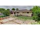 Back exterior of home with the back door, deck, and brick patio at 9743 W 67Th Pl, Arvada, CO 80004