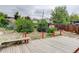 Spacious backyard with a wooden deck and lush greenery with views of neighborhood homes at 9743 W 67Th Pl, Arvada, CO 80004