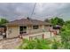 The back of the home with a wooden deck and sliding glass door to the interior at 9743 W 67Th Pl, Arvada, CO 80004