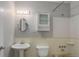 Traditional bathroom with vanity, toilet, and shower with a cabinet above the toilet at 9743 W 67Th Pl, Arvada, CO 80004