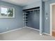 This is a cozy bedroom with a window, closet, and shelving at 9743 W 67Th Pl, Arvada, CO 80004