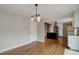 Open dining room area with hardwood floors flows into the modern kitchen, perfect for entertaining at 9743 W 67Th Pl, Arvada, CO 80004