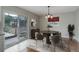 Bright dining area featuring a modern chandelier, sleek decor, and sliding glass doors to the patio at 9743 W 67Th Pl, Arvada, CO 80004