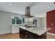 Bright kitchen with granite countertops, stainless steel appliances, white cabinets, and a large window at 9743 W 67Th Pl, Arvada, CO 80004