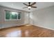 Bright living room with hardwood floors, neutral walls, ceiling fan and large windows at 9743 W 67Th Pl, Arvada, CO 80004