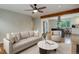 Living room with hardwood floors, ceiling fan, and open floorplan to the kitchen at 9743 W 67Th Pl, Arvada, CO 80004