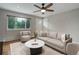 Bright living room with hardwood floors, neutral walls, ceiling fan and large windows at 9743 W 67Th Pl, Arvada, CO 80004