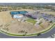 Aerial view showcasing community amenities including a pool, tennis courts, clubhouse, and parking at 21972 E Allenspark Dr, Aurora, CO 80016