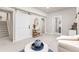 Finished basement area featuring a sliding barn door, plush carpeting, and modern decor at 21972 E Allenspark Dr, Aurora, CO 80016