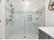 Sleek bathroom with a glass-enclosed shower, marble tile, modern fixtures, and built-in niche at 21972 E Allenspark Dr, Aurora, CO 80016