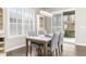 Elegant dining room with a marble-top table, stylish chairs, and natural light from large windows at 21972 E Allenspark Dr, Aurora, CO 80016