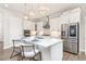 Modern kitchen with white cabinets, quartz countertops, stainless steel appliances, and pendant lighting at 21972 E Allenspark Dr, Aurora, CO 80016