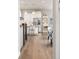Bright kitchen featuring stainless steel appliances, white cabinetry, pendant lighting, and hardwood floors at 21972 E Allenspark Dr, Aurora, CO 80016