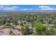 Expansive aerial shot showcasing the neighborhood's lush greenery and mountain views at 2724 S Ames Way, Denver, CO 80227