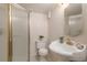 This bathroom features a sink with gold fixtures, a shower, and a toilet at 2724 S Ames Way, Denver, CO 80227